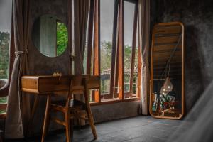 a room with a desk and a mirror and a ladder at Padangan Lodge By Bali Cabin in Padangan