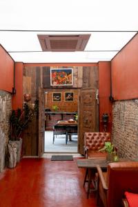 a living room with red walls and a table at Rinvada House in Bangkok