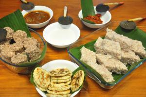 a table topped with plates of food and bowls of food at Ilukketiya Tea Chalets in Galle