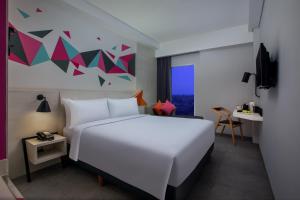 Voodi või voodid majutusasutuse favehotel Madiun toas