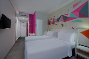 Voodi või voodid majutusasutuse favehotel Madiun toas