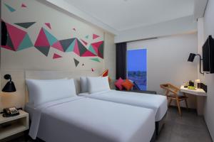 Voodi või voodid majutusasutuse favehotel Madiun toas