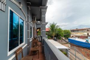 a balcony with a view of a building at SOVANN'S HOUSE By Uncle's House in Siem Reap