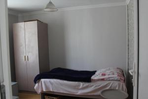 a bedroom with a bed and a white cabinet at Nunuka House in Tserovani