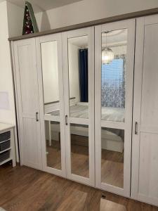 a white cabinet with glass doors in a room at Y&Y apartments in Bratislava
