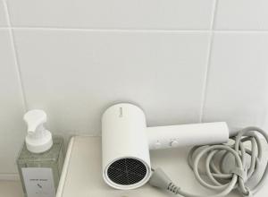 a white heater on a counter next to a wall at Beachfront house in Chaloklum in Mae Haad
