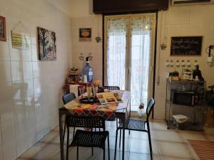 uma cozinha com mesa e cadeiras num quarto em La casa di Titty em Villa San Giovanni