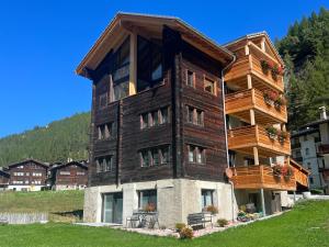 a tall building with balconies on the side of it at Ferienhaus Capricorn **** in Saas-Grund