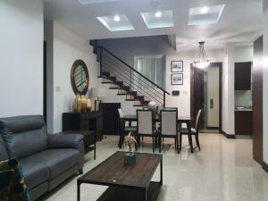 a living room with a couch and a table at lovely gated 3 BEDROOM in Kingston