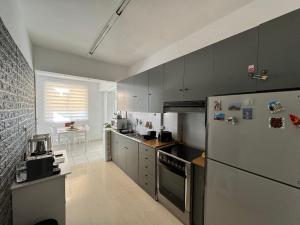 a kitchen with gray cabinets and a refrigerator at WINDSOR PLACE APARTMENT - SELF CHECKIN with CODE in Athens +13 photos