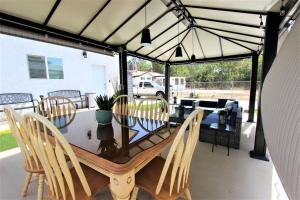 a dining table and chairs under a tent on a patio at Secluded & Quiet Guest House-Cherry Valley-Morongo in Cherry Valley