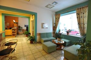 a living room with a couch and a table at Hotel Avra in Volos