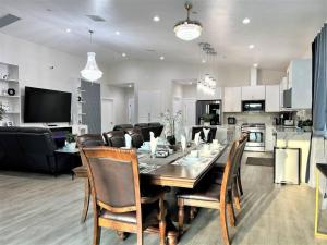 a dining room and living room with a table and chairs at New & Modern with Accessibility-Family Friendly in San Bernardino