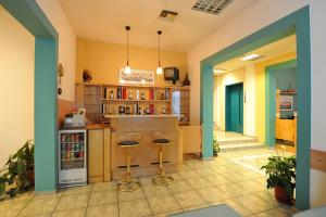 a large kitchen with two bar stools in a room at Hotel Avra in Volos