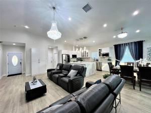 a large living room with a couch and a kitchen at New & Modern with Accessibility-Family Friendly in San Bernardino