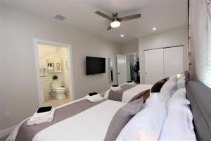 a bedroom with two beds and a flat screen tv at New & Modern with Accessibility-Family Friendly in San Bernardino