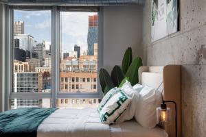 a bedroom with a large window with a city view at Chicago get Away in Chicago