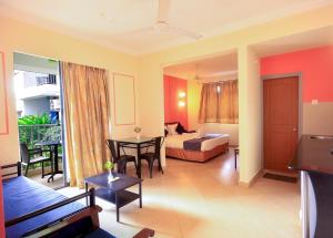 a hotel room with a bed and a table at Aastha Escape Resort near Calangute Beach in Calangute
