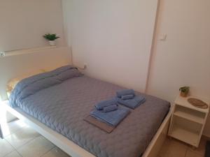 een bed met twee handdoeken in een kamer bij Aelia Studio in Larisa