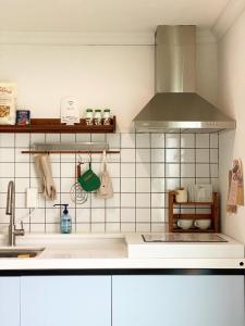 a kitchen with a sink and a stove at TAB Apartment in Busan