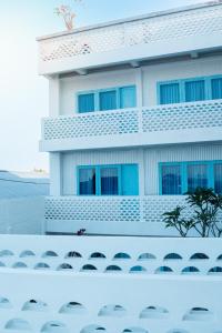 a building with chairs in front of it at Paras Paros Marina Lodge in Sanur