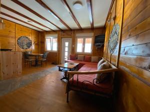 a living room with a couch and a table at Grande Apartman Nature Connection Drina in Bajina Bašta