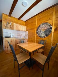 a dining room with a wooden table and chairs at Grande Apartman Nature Connection Drina in Bajina Bašta
