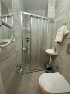 a bathroom with a shower and a toilet and a sink at Kadıköy Miski Amber in Istanbul