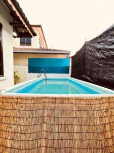 a large swimming pool in a backyard with a wooden fence at Modern Family Retreat by STAYco - PS4, Mini-Pool, Pool table - just 5 mins to Beach ! in Ayer Itam