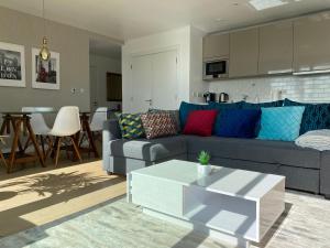 a living room with a couch and a table at 7th floor apartment in London