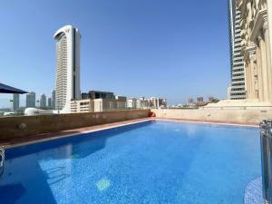 a large swimming pool on the roof of a building at Deluxe 1 Bedroom Apartment - Elite Residence Dubai Marina - Sea View in Dubai