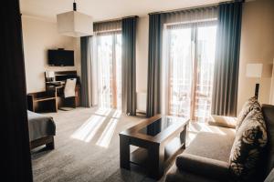 a living room with a couch and a coffee table at Hotel Elegance in Šumperk