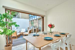 a dining room with a wooden table and chairs at 3 Bedrooms - Darling Harbour - Ada Place in Sydney