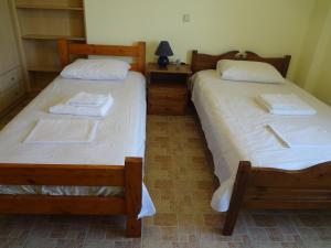 two beds sitting next to each other in a room at House in the grass land. in Órmos