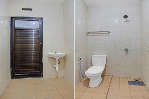 a bathroom with a toilet and a sink at OYO 90735 Palem Garden 2 in Tulungagung