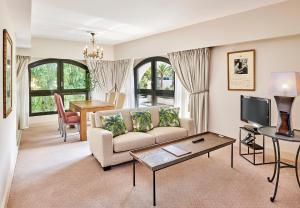 a living room with a couch and a table at La Résidence de La Réserve in Beaulieu-sur-Mer