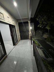 a hallway of a building at night with stairs at Hidden Gem Uluwatu Apartments in Uluwatu