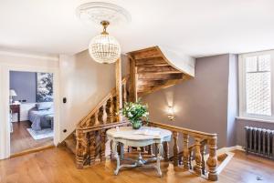 a dining room with a staircase and a table at Le Clos Marguerite - Maison d'Hôtes in Ammerschwihr