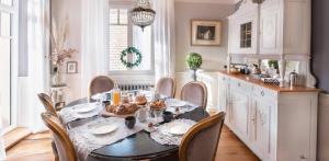 a dining room with a table with food on it at Le Clos Marguerite - Maison d'Hôtes in Ammerschwihr +3 photos
