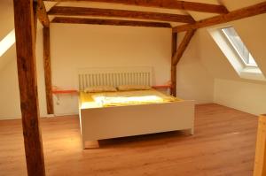 a bedroom with a bed in an attic at Lehmhäuschen mit Sauna in Tangermünde