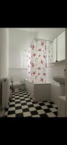 a bathroom with a toilet and a checkered floor at St Andrews Mansions in London