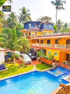a large house with a swimming pool in front of it at Veronica By The Beach Calangute in Calangute
