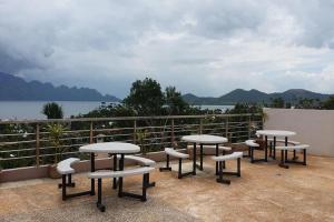 a group of tables and chairs on top of a balcony at Micasa Lodge Palawan in Coron