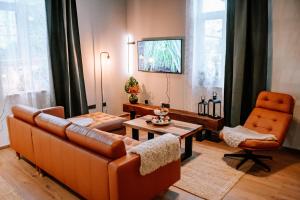 a living room with a couch and two chairs and a table at Apartman Saturn in Osijek