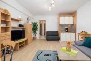 a living room with a couch and a table at Comfy Studio Turystyczna 300 m to the beach by Renters in Międzyzdroje