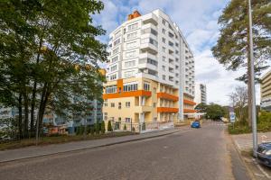 a tall white building on the side of a street at Comfy Studio Turystyczna 300 m to the beach by Renters in Międzyzdroje