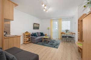 ein Wohnzimmer mit einem Sofa und einem Tisch in der Unterkunft Comfy Studio Turystyczna 300 m to the beach by Renters in Misdroy