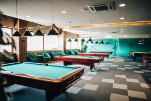 a row of pool tables in a room at Hotel Elegance in Šumperk