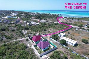 an aerial view of a house with a road next to the beach at ✰Secluded House w/King Bed near Beach-5 min walk✰ in Pingwe