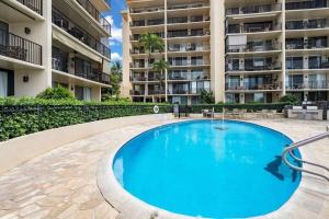 a swimming pool in front of a large apartment building at Hololani B603- Beautiful ocean views at this 2 bedroom condo in Kahana